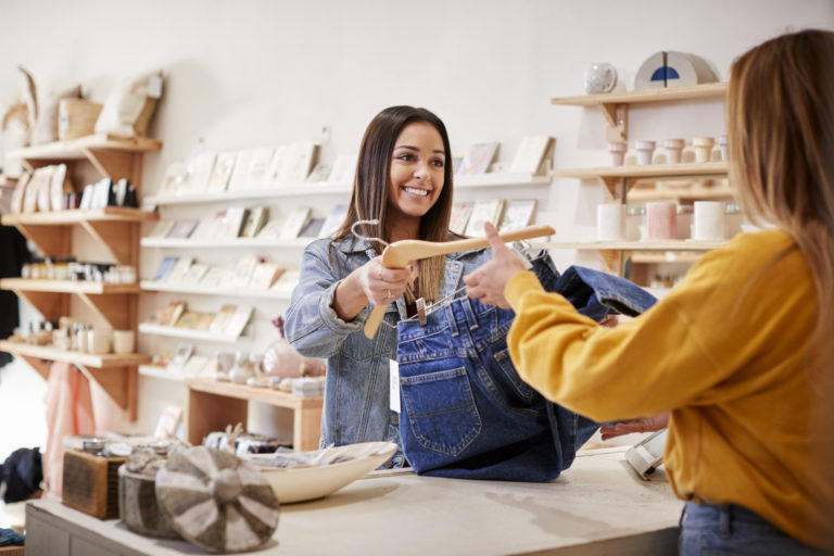 Female Sales Assistant In Independent Clothing And Gift Store Serving Female Customer